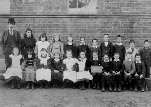 Black and white image of a group of pupils Cheltenham State School with teachers