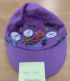Purple cap with Falls Creek and 12 badges attached