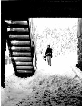 Thea framed by the staircase with building in the background.