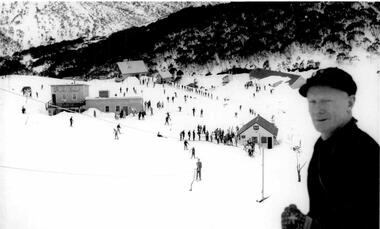 Sandy McNabb in the foreground overlooking skiers and buildings at Falls Creek, Victoria