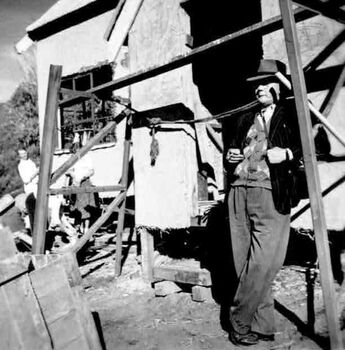 Working on Bogong buildings with man on right enjoying the view.