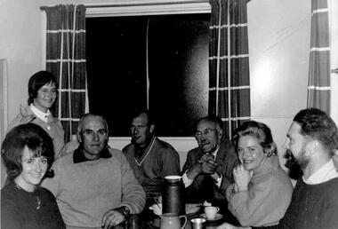 A group of family and friends sitting around a table