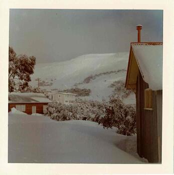 A view from Bowna looking towards the summit. Snow covered buildings on both sides of the photo