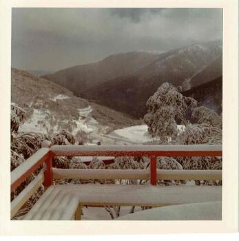 Looking towards the lower car park from balcony. Snow covered hills and threatening sky.