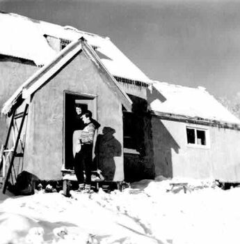 Close up view of Albury Ski Club Lodge with two women standing in the doorway.
