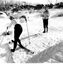 Two women on the snow. Women on left is looking at camera over her shoulder. Second woman facing camera.