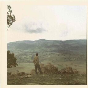 Fred Griffith looking at mountains. Location unknown