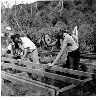 Men working on the timber foundations of the lodge.