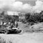 Partly constructed building and group of men and a truck