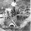 A group of three people working on the cellar. two are at the top and the other is inside.