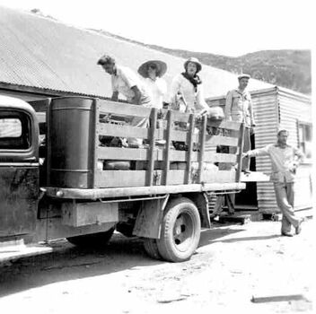 A group of men on a loaded truck