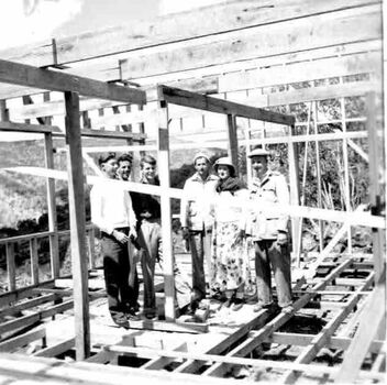 A group of people standing inside the framework