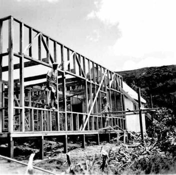 Two workers standing in frame for walls