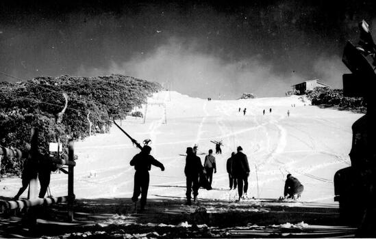 Skiers gathered at the foot of the mountain. Chairlift on the left
