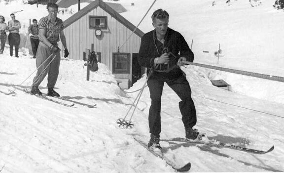 Skier on the tow with others in the background