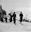 Four skiers preparing to ski at Bogong. Building on left