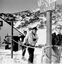 Skiers lined up at the tow beneath a sign for the Nissen Ski School