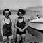 A photo of Fred Griffith's daughters at the Hume Weir with people relaxing on a boat to the right.