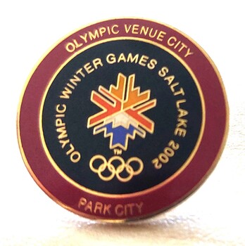 Round badge with a colourful stylised snowflake used as the emblem for Salt Lake City