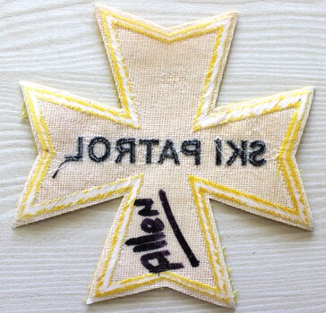 Reverse of patch showing white textile backing. The name "Allen" has been written on it.