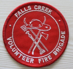 Red and white cloth patch showing outline of skis, fireman's hat and axe