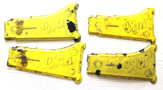 Four yellow metal wax scrapers imprinted with "Toko"