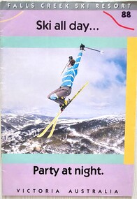 A skier jumping in the air above mountains in the background