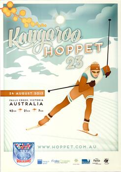 A skier dressed with mountains and sky in the background. A sprig of wattle is in the upper left corner. 