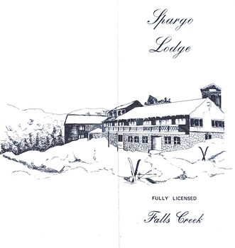Image of the whole building with skis and poles on ground.