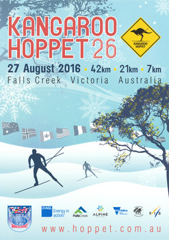 Two skiers crossing gentle slopes passing a tree under a line of flags.