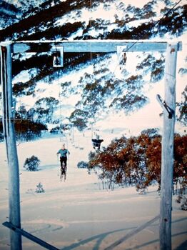 A skier riding the Alpine Chairlift