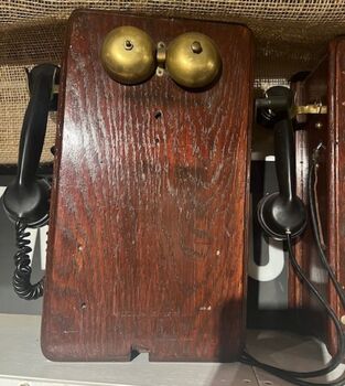 Telephones showing brass bell and handles