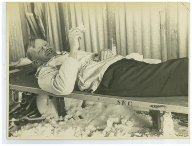 Ray Meyer on stretcher in hut near Mt. Nelse