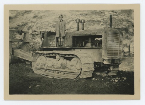 John Meyer standing on small grader.