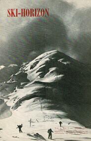 Three skiers at the foot of a mountain with a storm threatening.