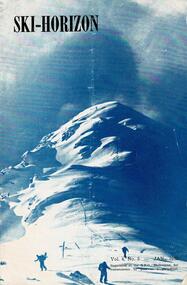 Three skiers at the foot of a mountain with a storm threatening.