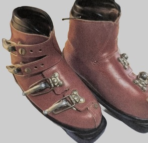 Red ski boots with four metal buckles