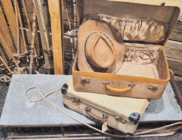 A vintage sled and well-travelled suitcase