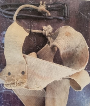 A nutcracker attached to the belt by rope.
