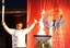 Steve Lee lights the cauldron at the Hotham Village after carrying it down the mountain,