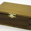 Honey coloured rectangular wooden box with hinged lid, secures at front with gold clasp