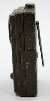 Khaki coloured, metal rectangular box-like torch.
