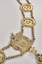 Close up of gold coat of arms and adjoining links which sits at the centre bottom of the chain. 