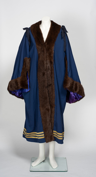 7/8th length navy ceremonial robe with fur collar and cuffs and three lines of gold braid along hem. 