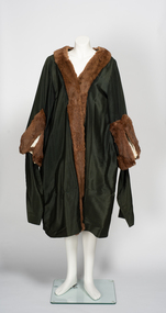 Green ceremonial robe with fur trim around cuffs and collars.
