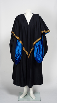 Black ceremonial / academic robe, lined with blue fabric and decorated with three gold braid stripes. 