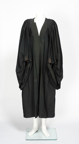 3/4 length black ceremonial robe with pleated shoulder detail.