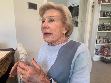 A photograph of an older white woman talking