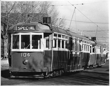 Black and White photograph of L class tram No. 104 and another L class while on a special tram tour.