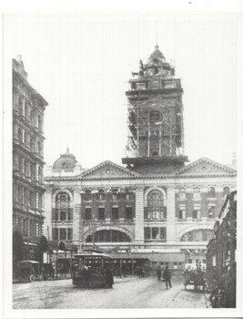 Photograph Flinders St station clocktower under construction with grip car reversing